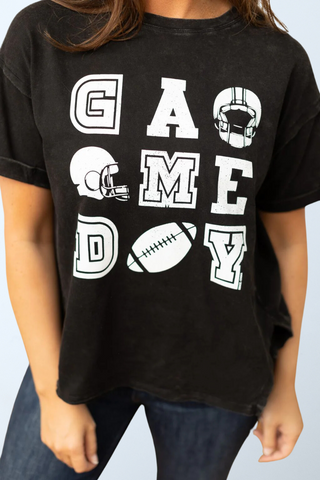 a woman wearing a black t - shirt that says game day