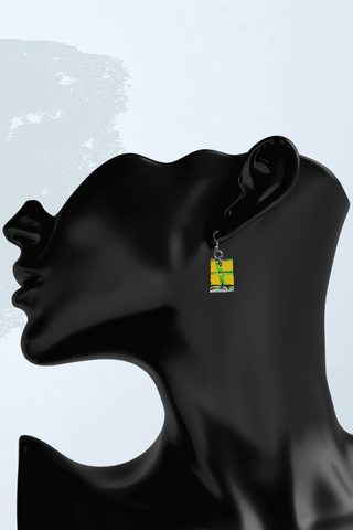 a black mannequin head with a pair of earrings on it