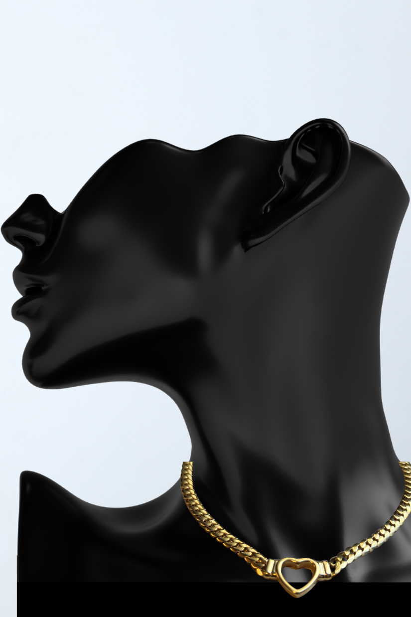 a black mannequin head with a gold necklace on it